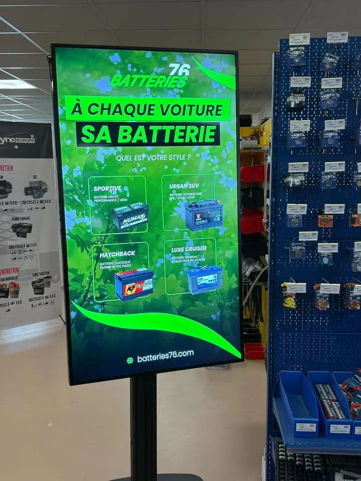 Totem LCD sur pied installé en magasin 76 Batteries affichant les gammes de batteries auto